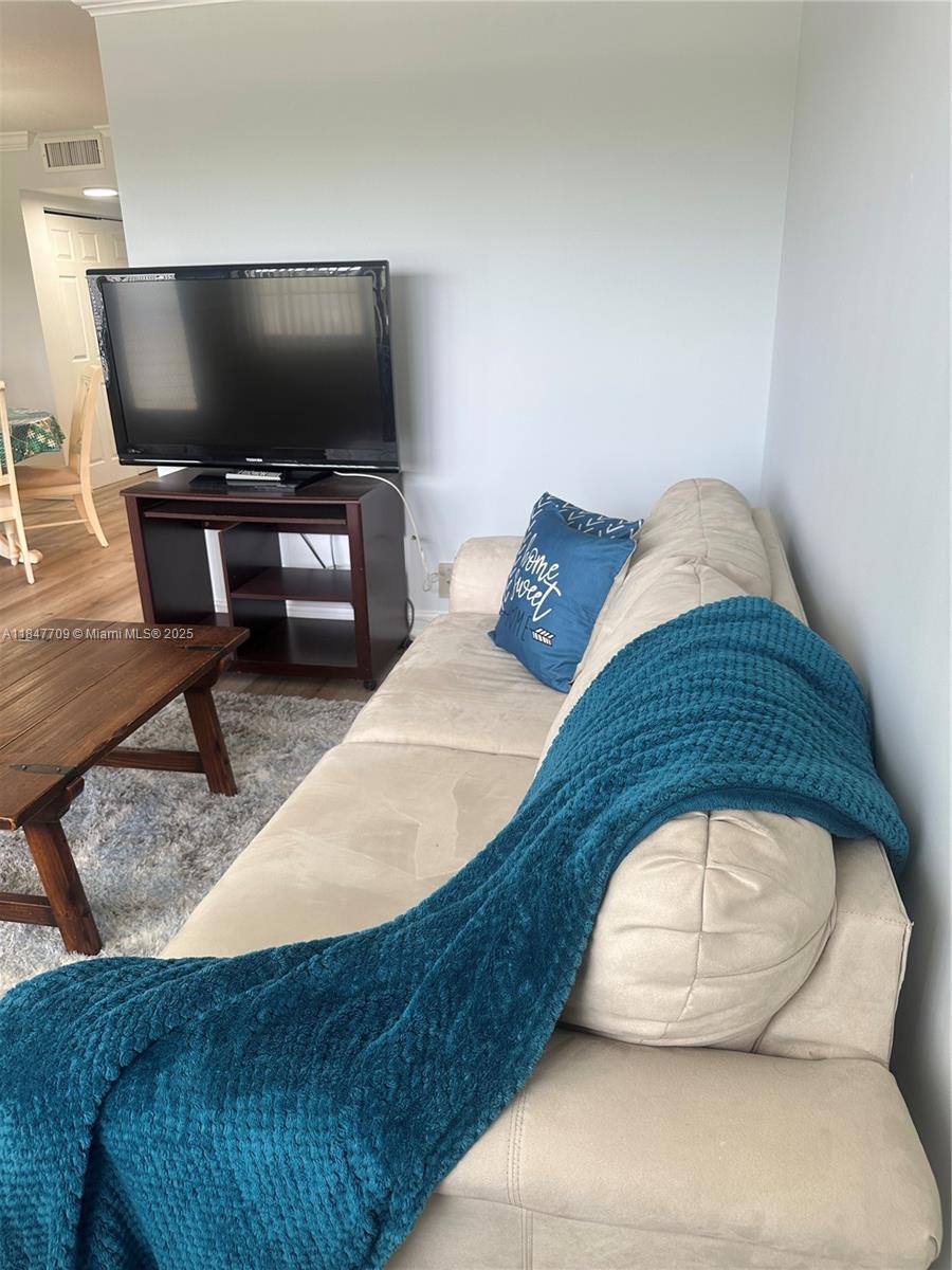 4027 Swansea Crescent, Unit 4027 Deerfield Beach, FL 33442 - Photo 5 of 47 a living room with a couch and a flat screen tv