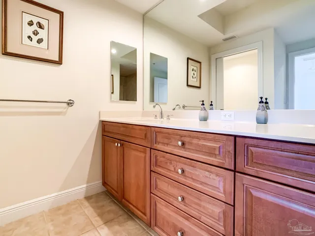 a bathroom with a double vanity sink and a mirror