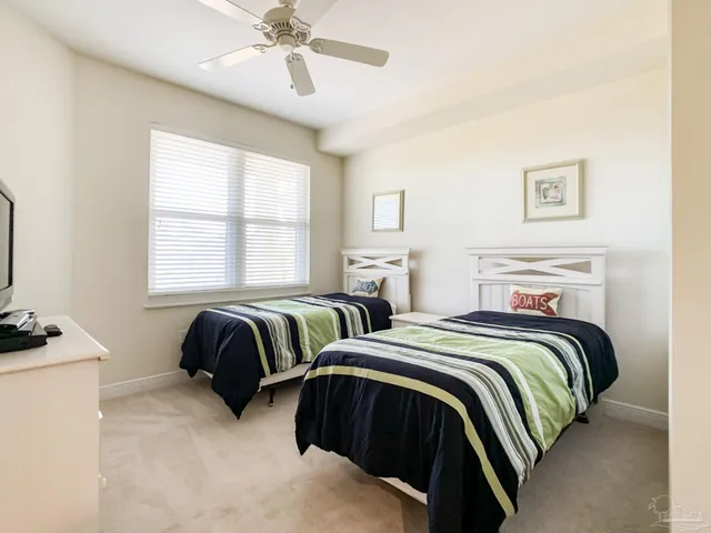 a bedroom with two beds and painting on the wall
