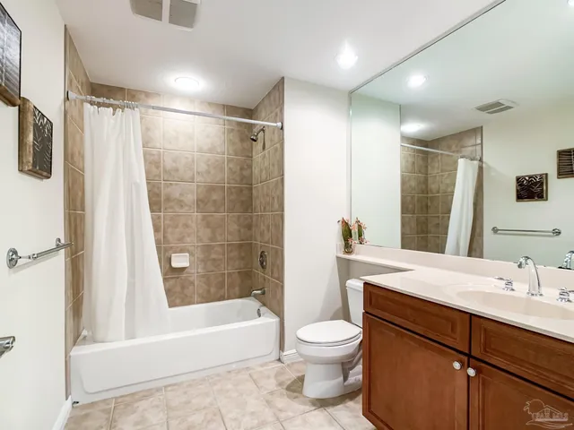 a bathroom with a bathtub shower sink vanity and toilet
