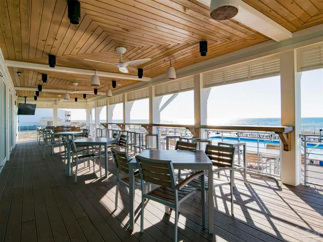 a view of a patio with dining table and chairs