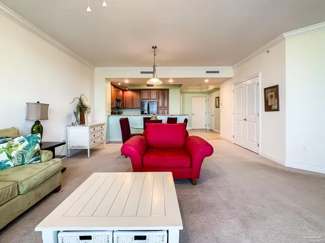 a living room with furniture and kitchen view