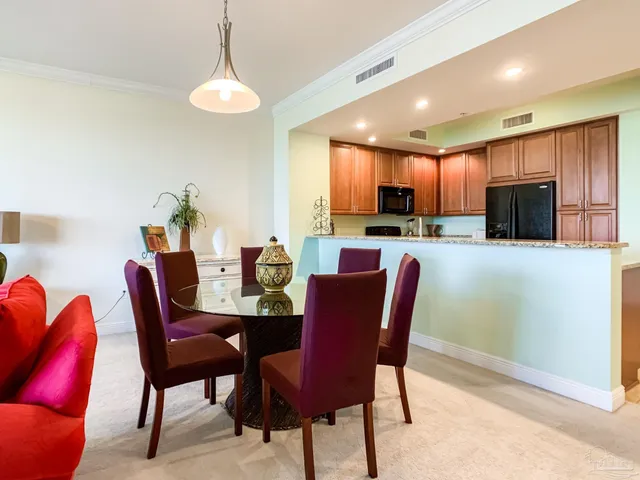 a dining room with furniture a window and a kitchen