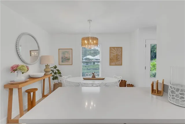 a view of a dining room with furniture and chandelier