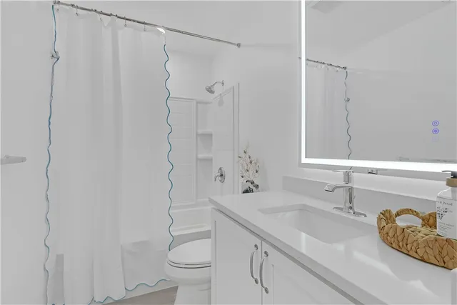 a view of a patio with a table and chairs under an umbrella