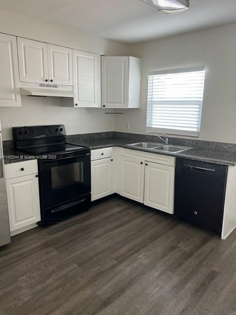 3524 Eagle Drive Orlando, FL 32804 - Photo 2 of 7 a kitchen with stainless steel appliances granite countertop a stove a sink and white cabinets