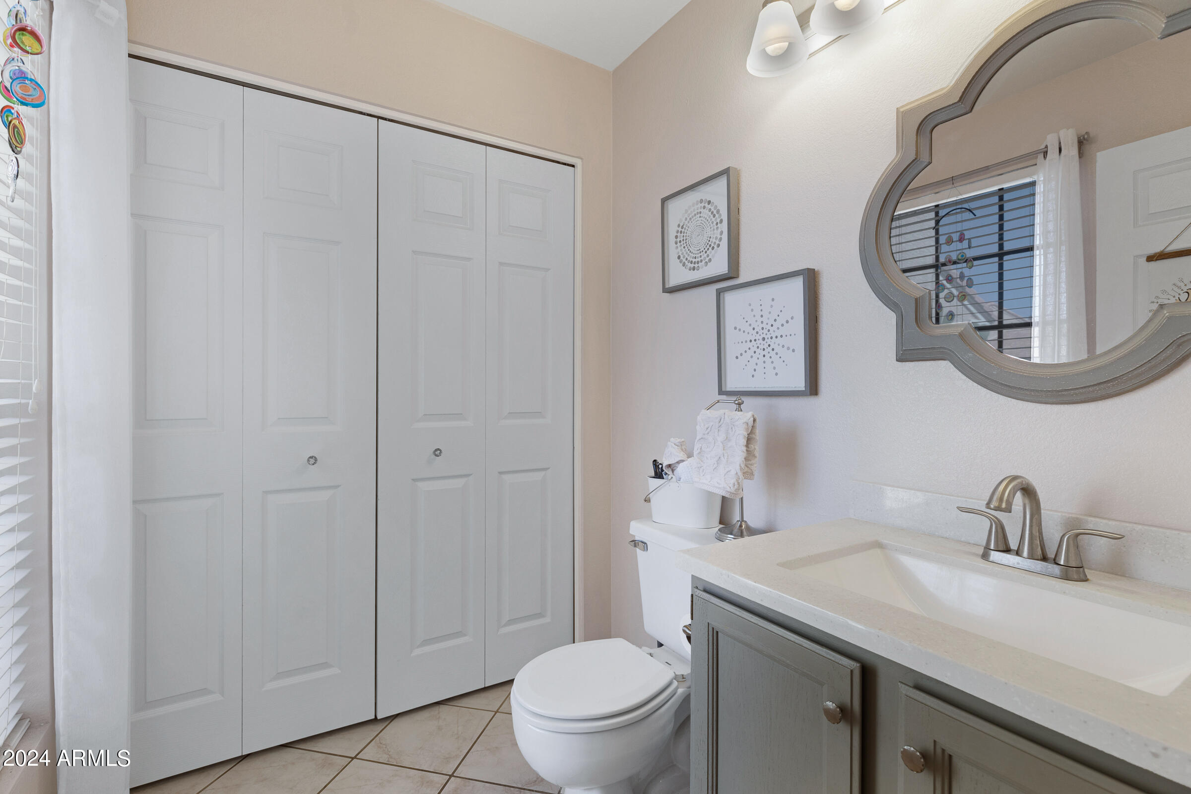 4142 East Agave Road Phoenix, AZ 85044 - Photo 18 of 30 a bathroom with a granite countertop sink a toilet and a mirror