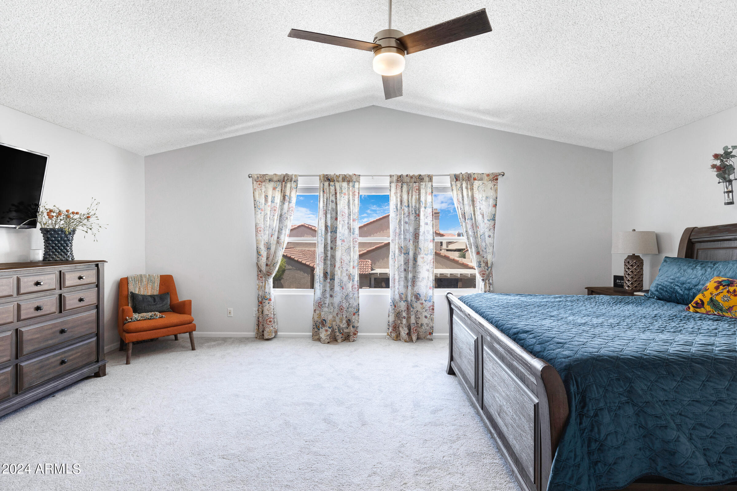 4142 East Agave Road Phoenix, AZ 85044 - Photo 23 of 30 a bed room with furniture and a flat screen tv
