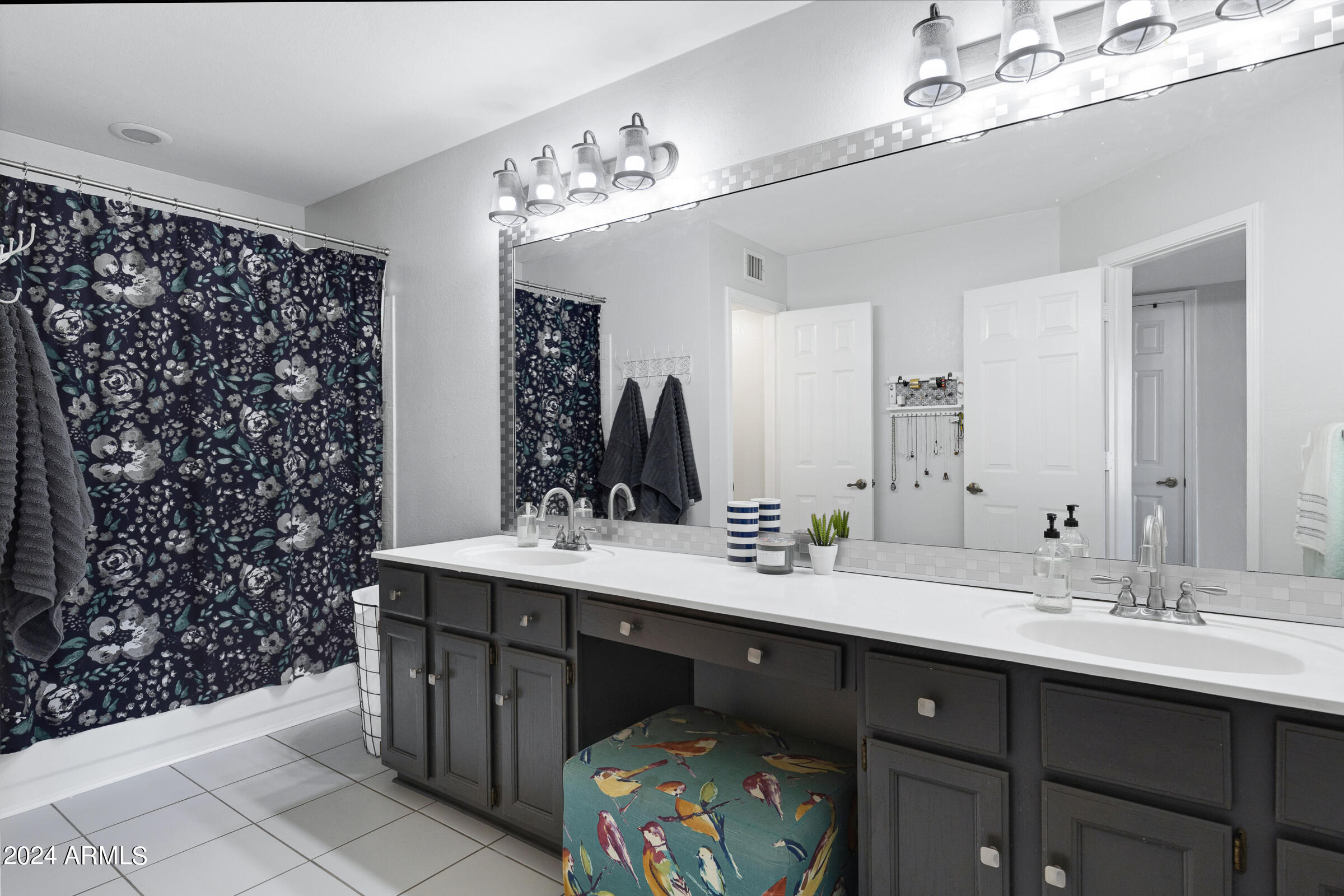 4142 East Agave Road Phoenix, AZ 85044 - Photo 26 of 30 a bathroom with a double vanity sink mirror and shower
