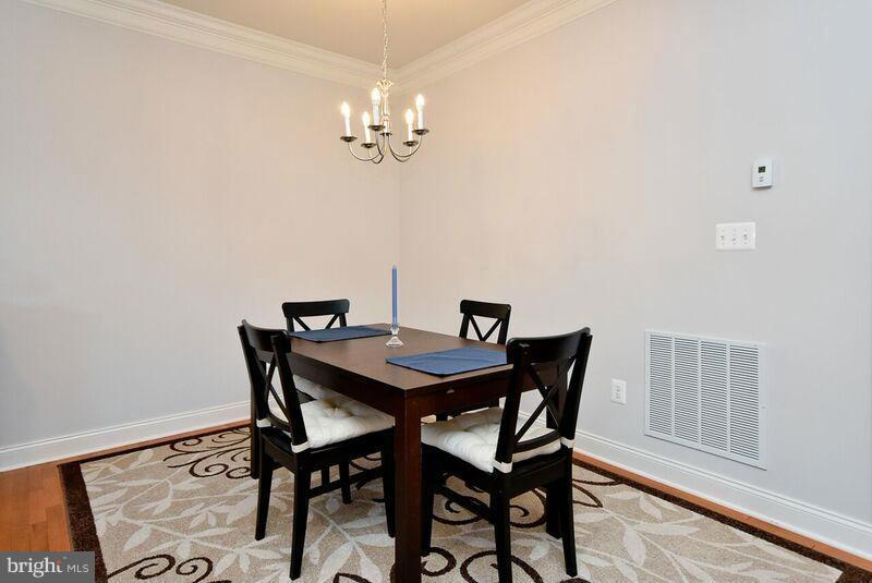 7616 Elmcrest Road Hanover, MD 21076 - Photo 9 of 30 a view of a dining room with furniture and wooden floor