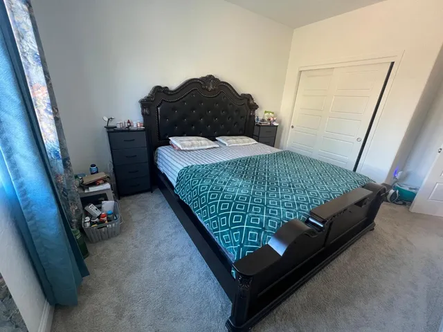 a bed sitting in a bedroom next to a window