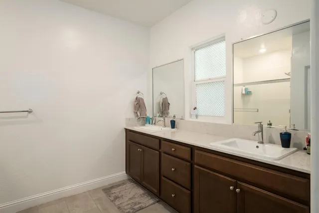 a bathroom with a double vanity sink and a mirror