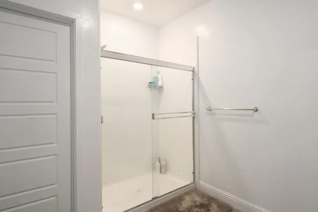a bathroom with a glass shower door