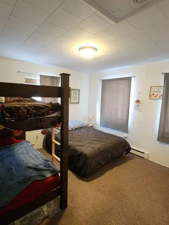 a bedroom with a bed and a mirror