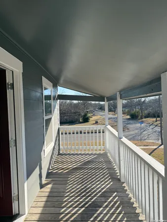 a view of balcony with wooden floor
