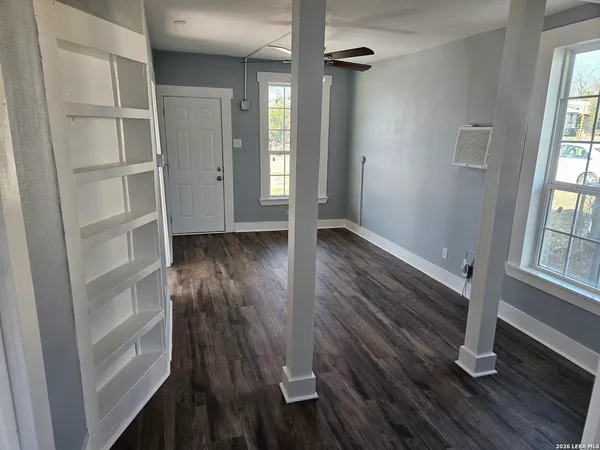 wooden floor in an empty room with a window