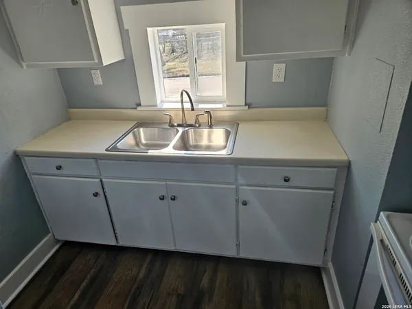 a room with a sink and cabinets