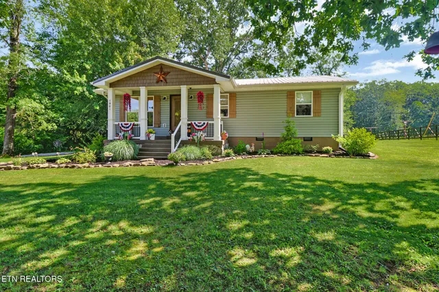 a front view of house with yard and green space