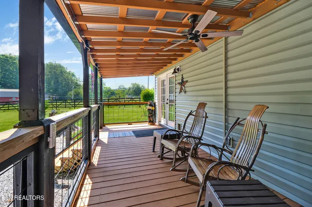 a view of a chairs and table in the balcony