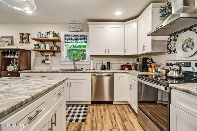a kitchen with a white cabinets and window