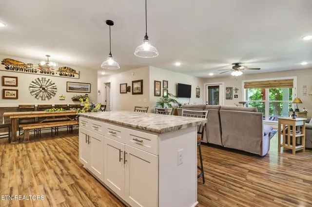 a kitchen with stainless steel appliances granite countertop a stove and a wooden floors