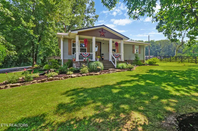 a front view of a house with a yard table and chairs