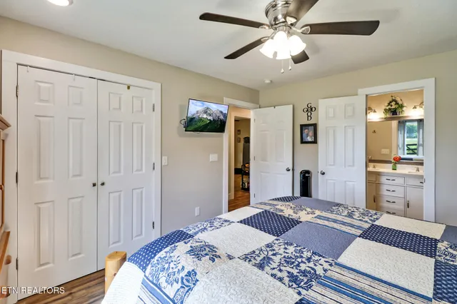 a bedroom with a large bed and a chandelier