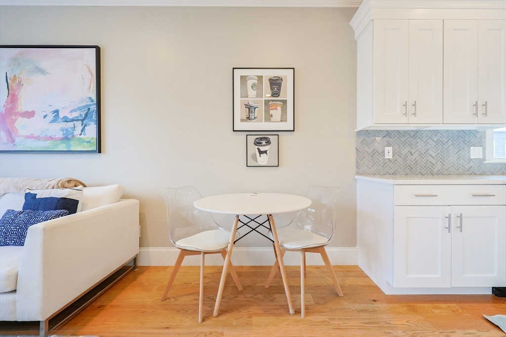 17 Washington Avenue, Unit 3 Waltham, MA 02453 - Photo 13 of 38 a view of a dining room with furniture and wooden floor