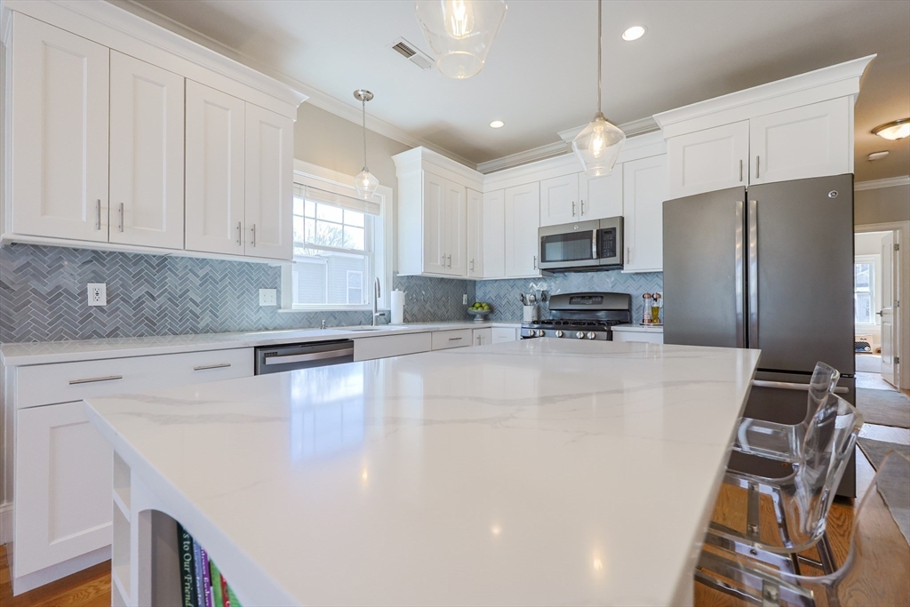 17 Washington Avenue, Unit 3 Waltham, MA 02453 - Photo 16 of 38 a kitchen with stainless steel appliances a refrigerator sink and microwave