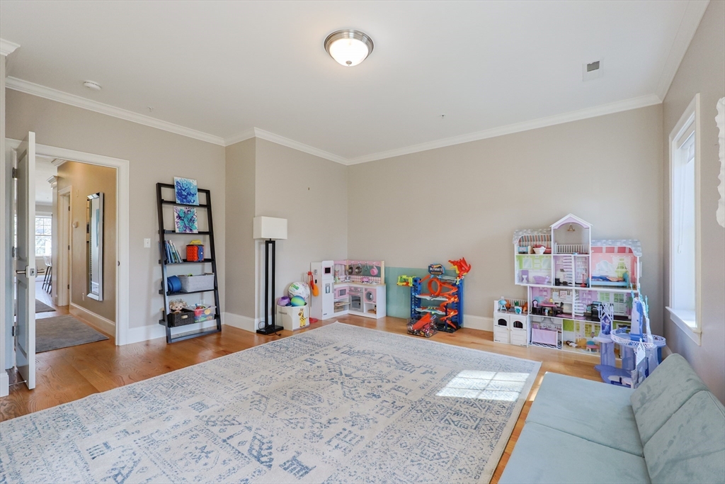 17 Washington Avenue, Unit 3 Waltham, MA 02453 - Photo 21 of 38 a children room with furniture and a wooden floor