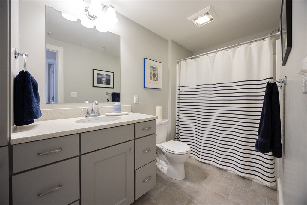 17 Washington Avenue, Unit 3 Waltham, MA 02453 - Photo 26 of 38 a bathroom with a toilet a sink and mirror