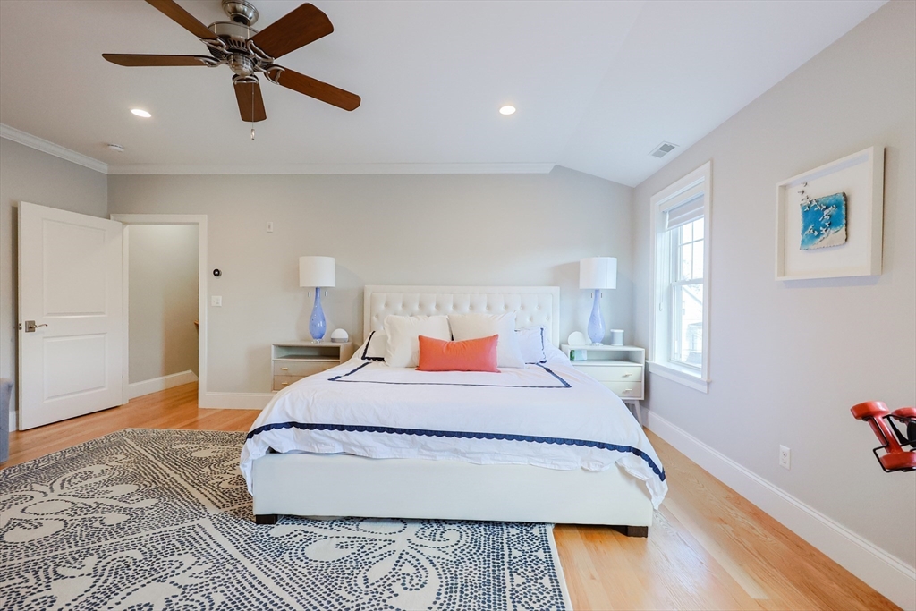 17 Washington Avenue, Unit 3 Waltham, MA 02453 - Photo 29 of 38 a bedroom with a bed and wooden floor