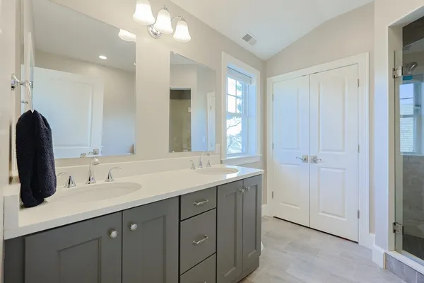 a bathroom with a sink double vanity and a mirror
