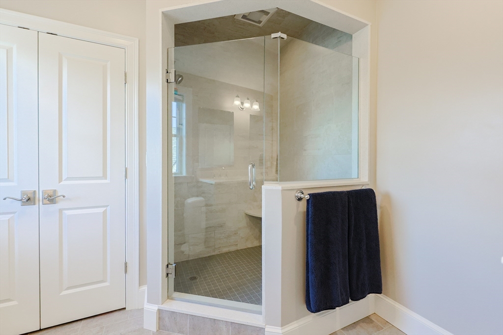 17 Washington Avenue, Unit 3 Waltham, MA 02453 - Photo 33 of 38 a bathroom with a mirror and a shower