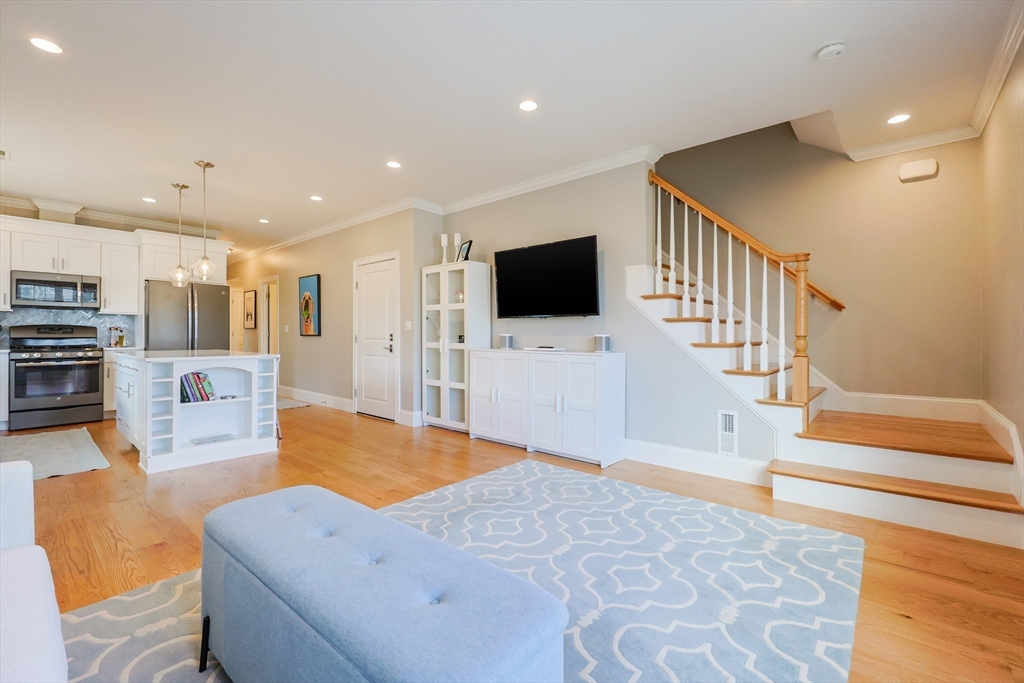 17 Washington Avenue, Unit 3 Waltham, MA 02453 - Photo 9 of 38 a living room with furniture and a flat screen tv