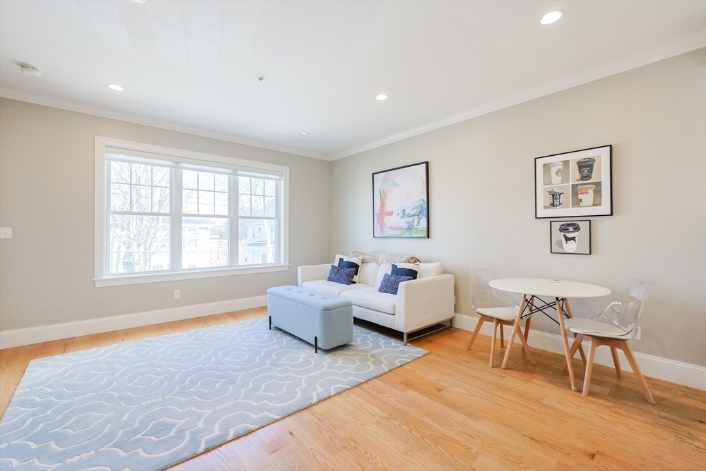 17 Washington Avenue, Unit 3 Waltham, MA 02453 - Photo 10 of 38 a living room with furniture and a window