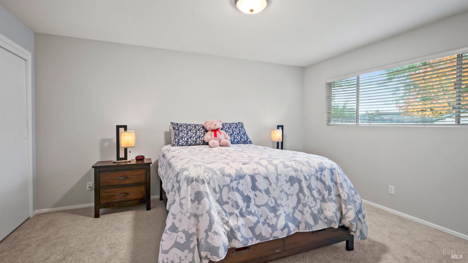 7 Portola Court Santa Rosa, CA 95409 - Photo 17 of 39 a bedroom with a bed and a window