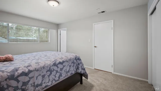 a bedroom with a bed and a window