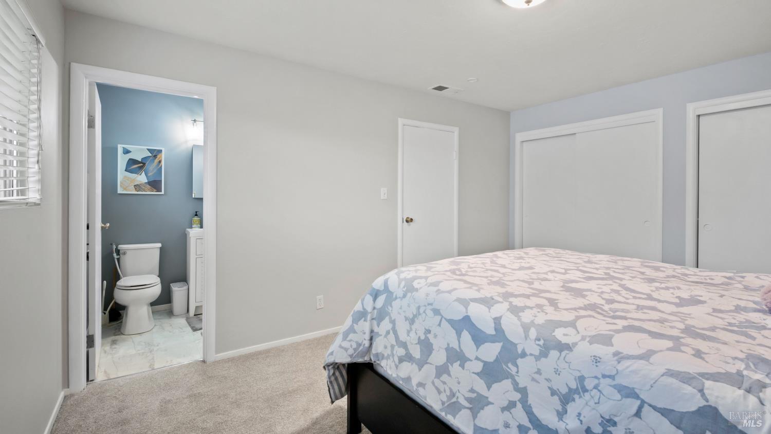 7 Portola Court Santa Rosa, CA 95409 - Photo 20 of 39 a bedroom with a bed and a view of bathroom