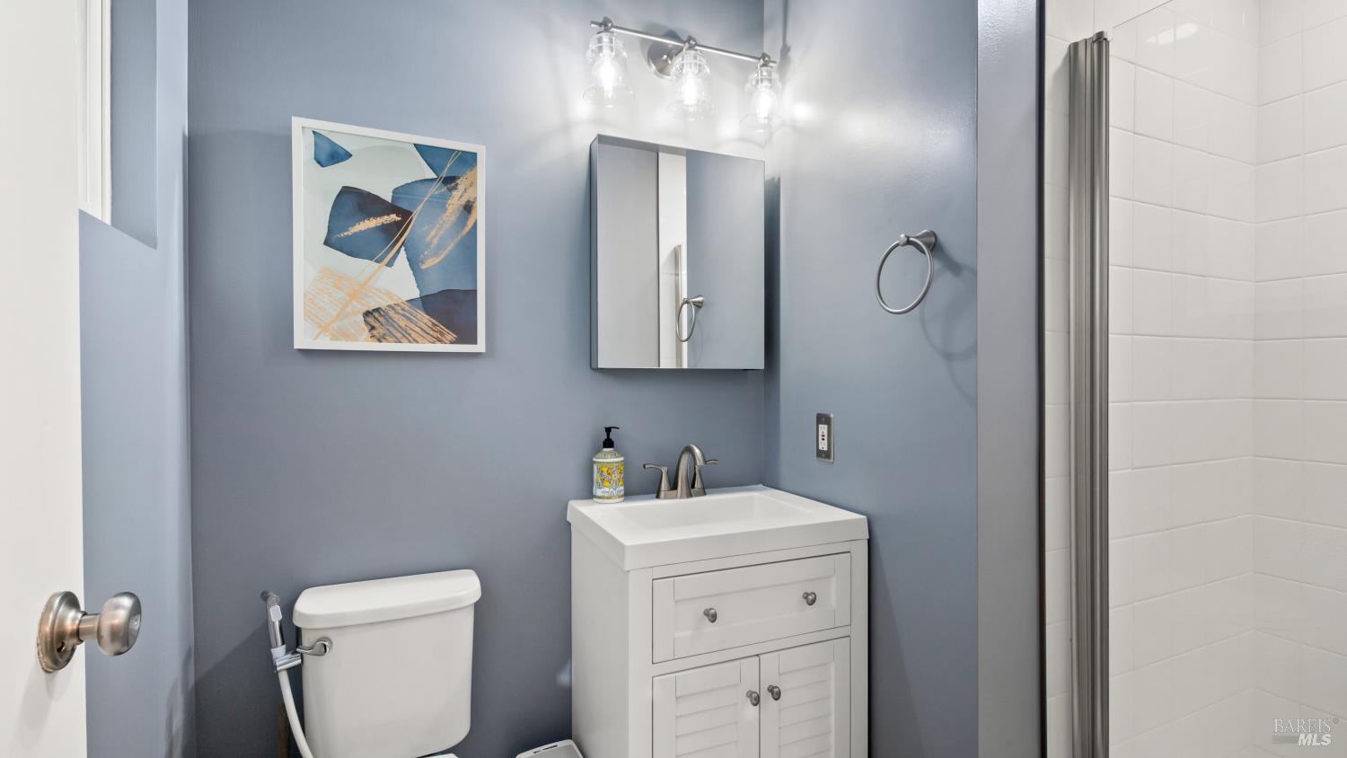 7 Portola Court Santa Rosa, CA 95409 - Photo 21 of 39 a bathroom with a toilet sink and mirror