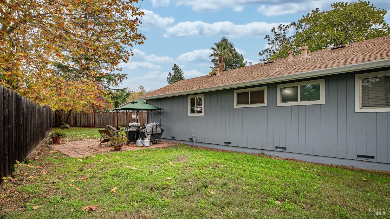 7 Portola Court Santa Rosa, CA 95409 - Photo 28 of 39 a backyard of a house with table and chairs