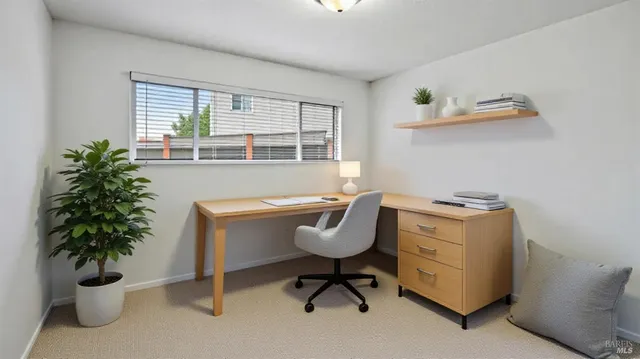 a bedroom with a bed and large window