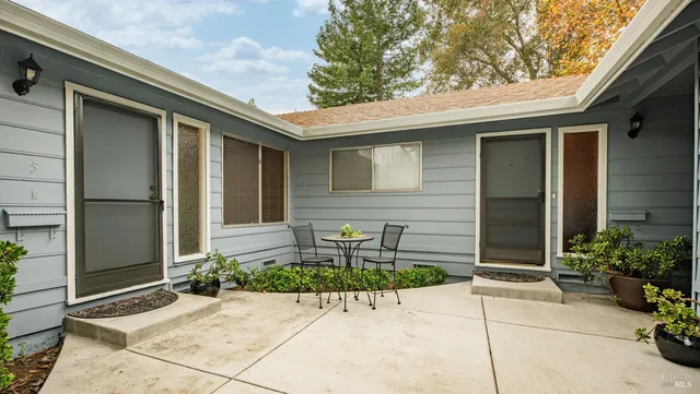 a front view of a house with a bench