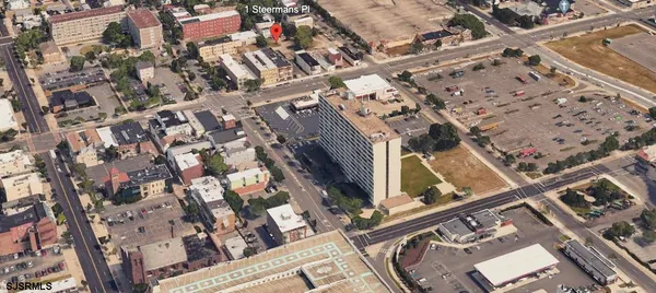 an aerial view of a residential apartment building with a yard
