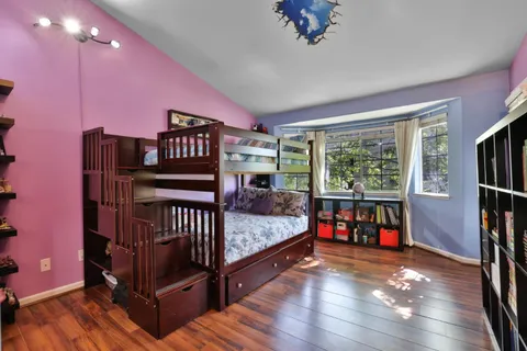 a bedroom with furniture and a flat screen tv