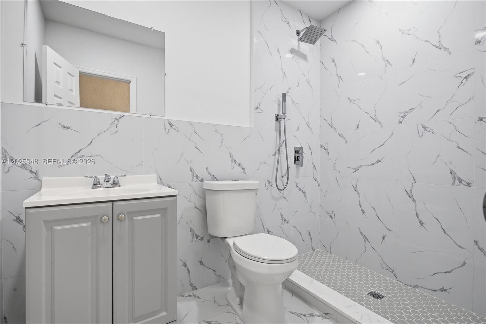 1745 Southwest 17th Street, Unit 2 Miami, FL 33145 - Photo 18 of 32 a bathroom with a sink a toilet and shower