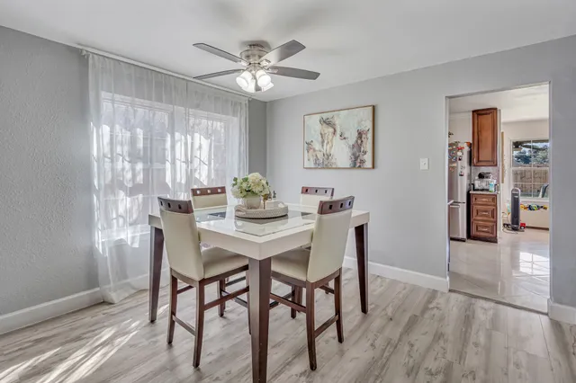 a view of a dining room with furniture and wooden floor