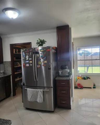 a kitchen with stainless steel appliances granite countertop a refrigerator and a stove