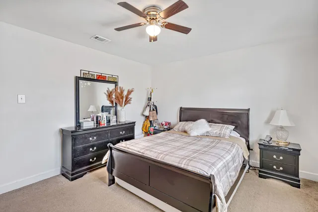 a bedroom with a bed and a desk