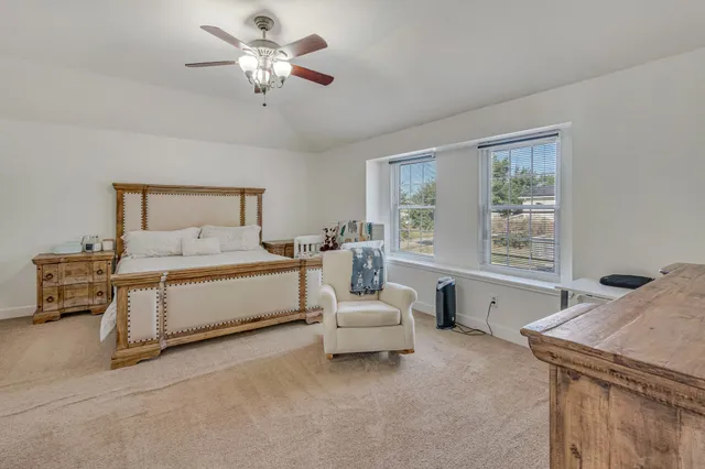 a spacious bedroom with a bed and a window